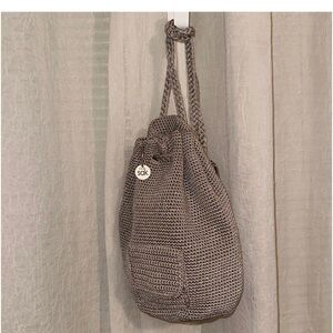 The Sak sling Backpack in the color mushroom